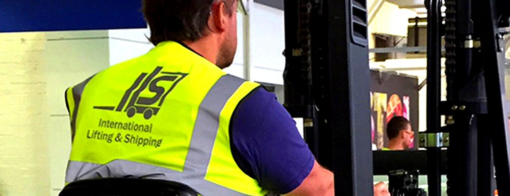 Un employé d’International Lifting & Shipping en tenue haute visibilité à ses couleurs