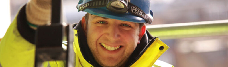 An electrician on site in high-visibility workwear