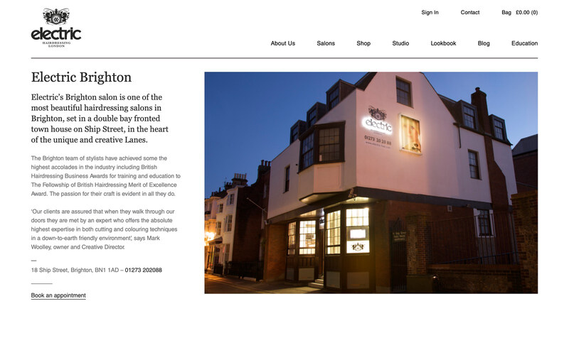 The Electric Brighton salon page, with the salon photographed at dusk, its address, telephone number and a link to book an appointment